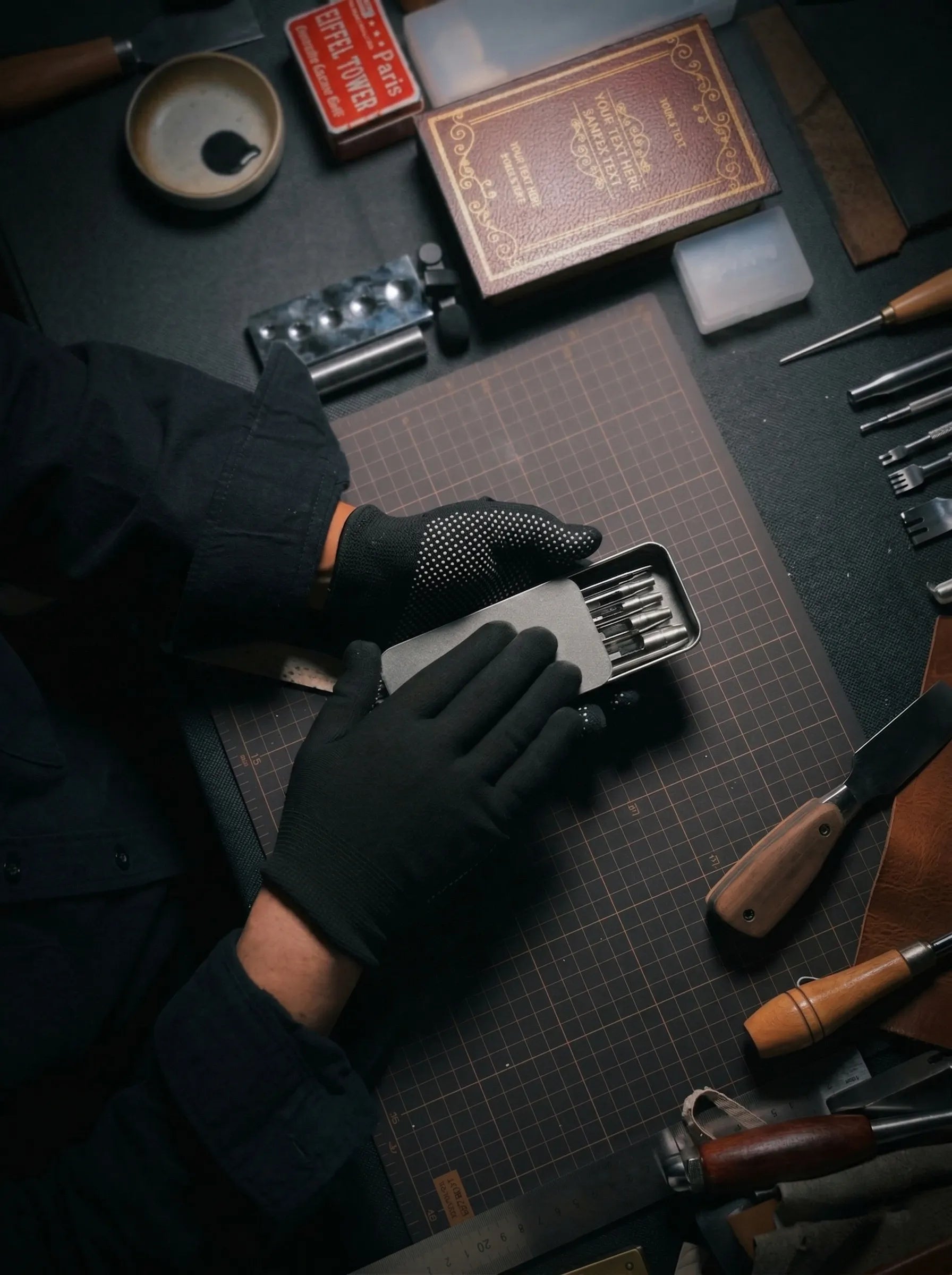 Above Zero Studio leather craft process with tools, leather swatches, and gloved hands