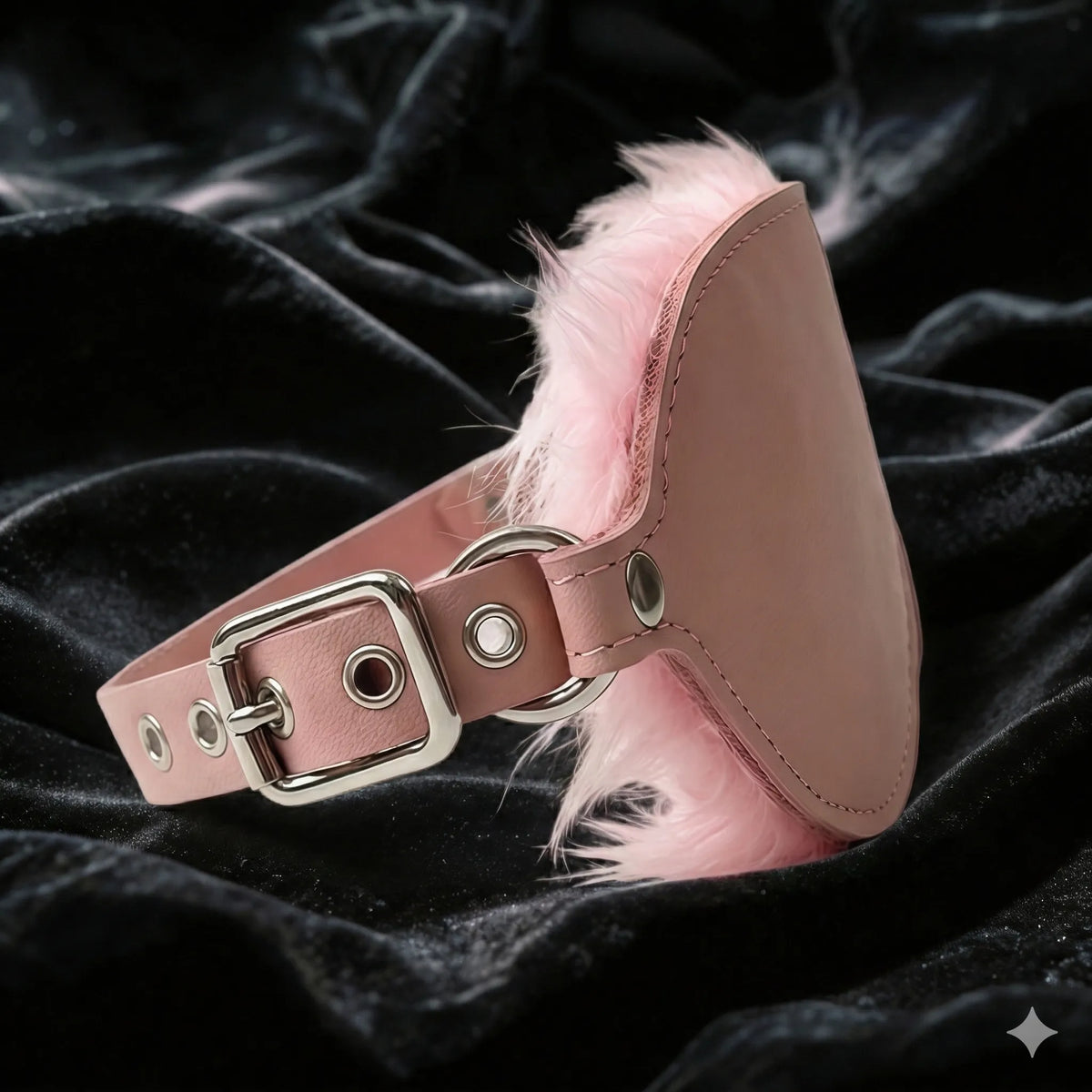 Blush Veil leather blindfold detail view with smooth blush leather exterior, stitching, and buckle attachment