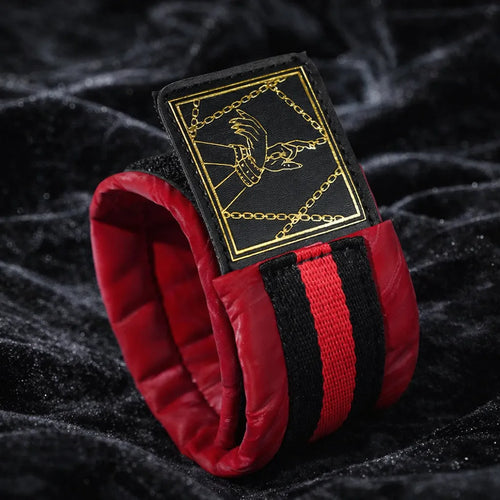 Crimson Order restraint set detail view with padded cuff construction, buckle hardware, and reinforced webbing