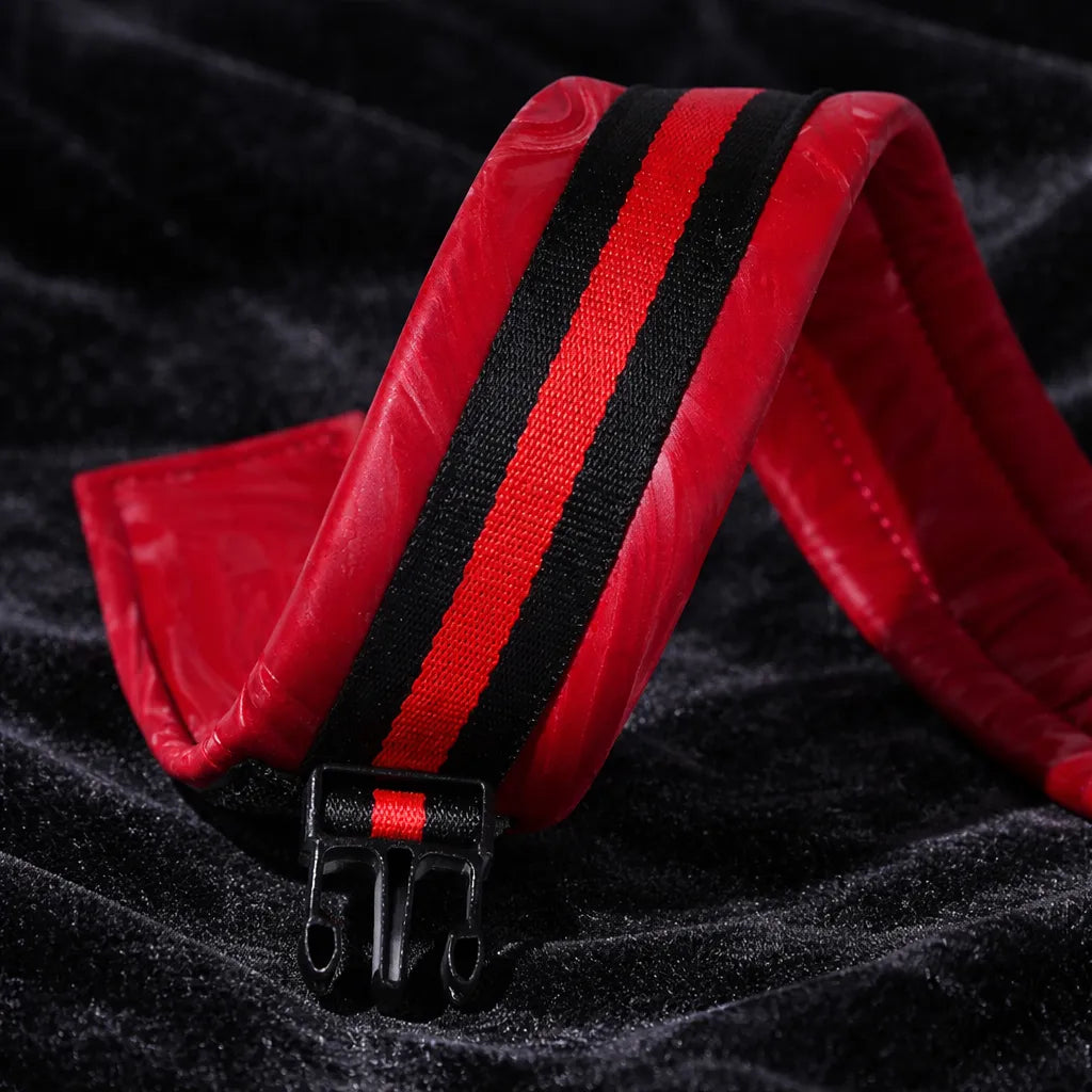 Crimson Order restraint set hardware detail view with thick buckle closure and black fastening straps