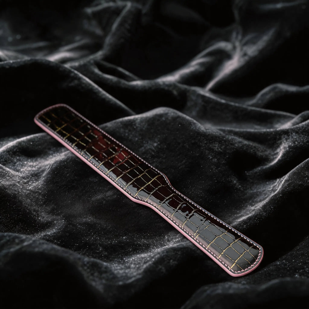 Noir Grid Patent Texture Leather Paddle black patent leather paddle on black satin with grid texture.