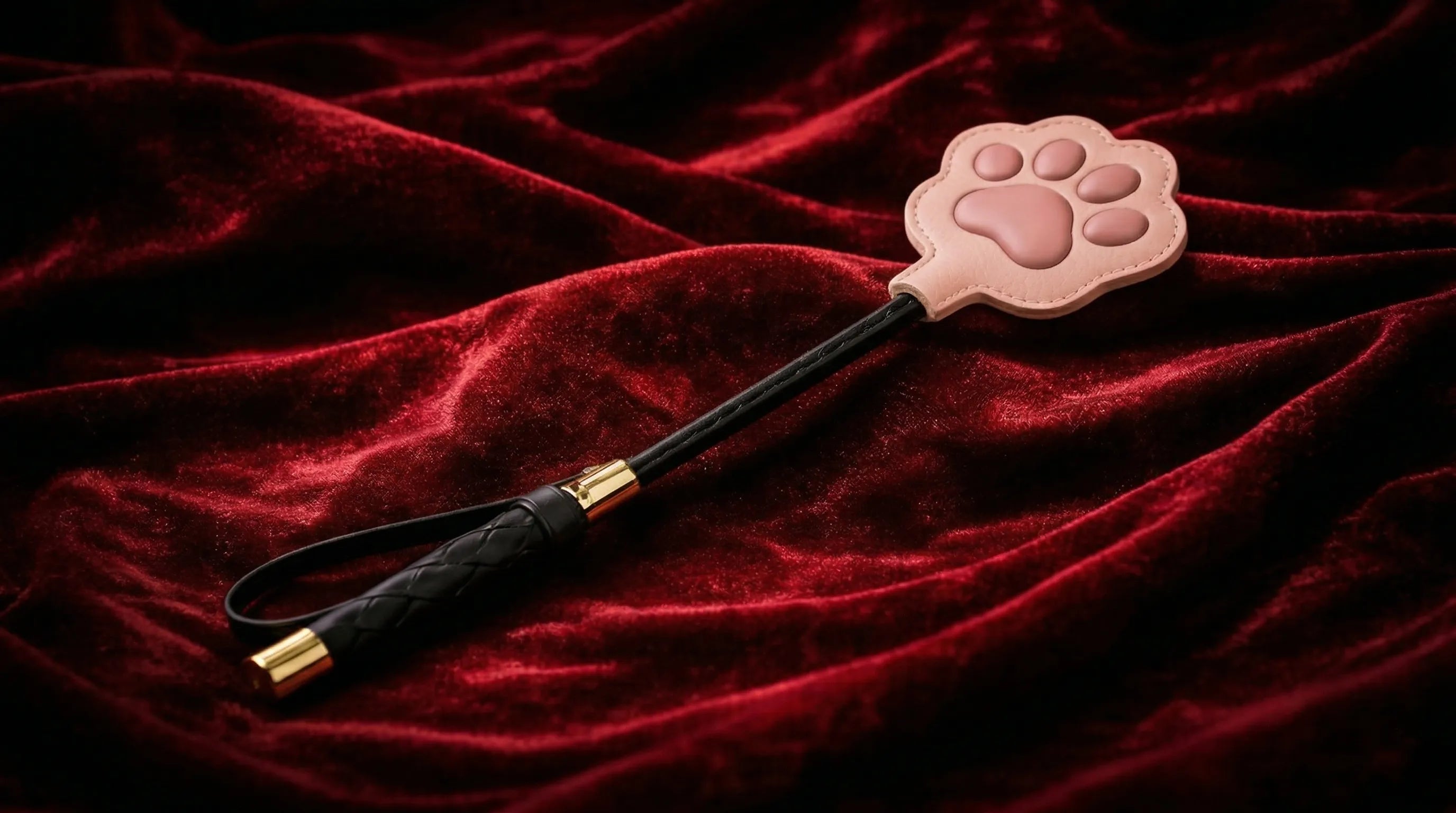 Paw Whisper cat paw paddle collection display on red velvet fabric