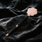 Paw Whisper leather paddle detail view with padded cat paw surface and stitched leather finish