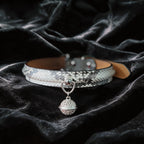 Python Echo Bell Leather Collar white and black python-textured leather collar on black satin with bell charm.