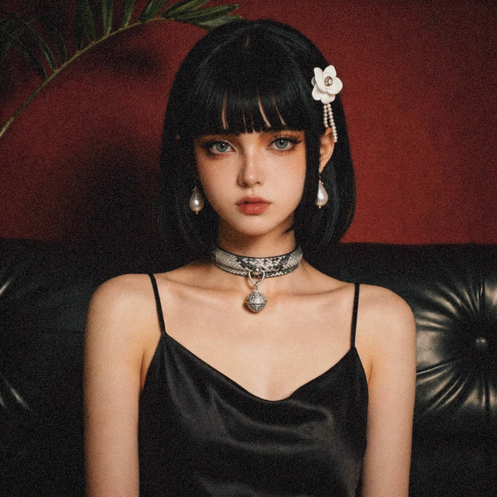 Python Echo Bell Leather Collar model-worn studio scene showing white and black python-textured leather and bell charm.