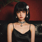 Python Echo Bell Leather Collar model-worn studio scene showing white and black python-textured leather and bell charm.