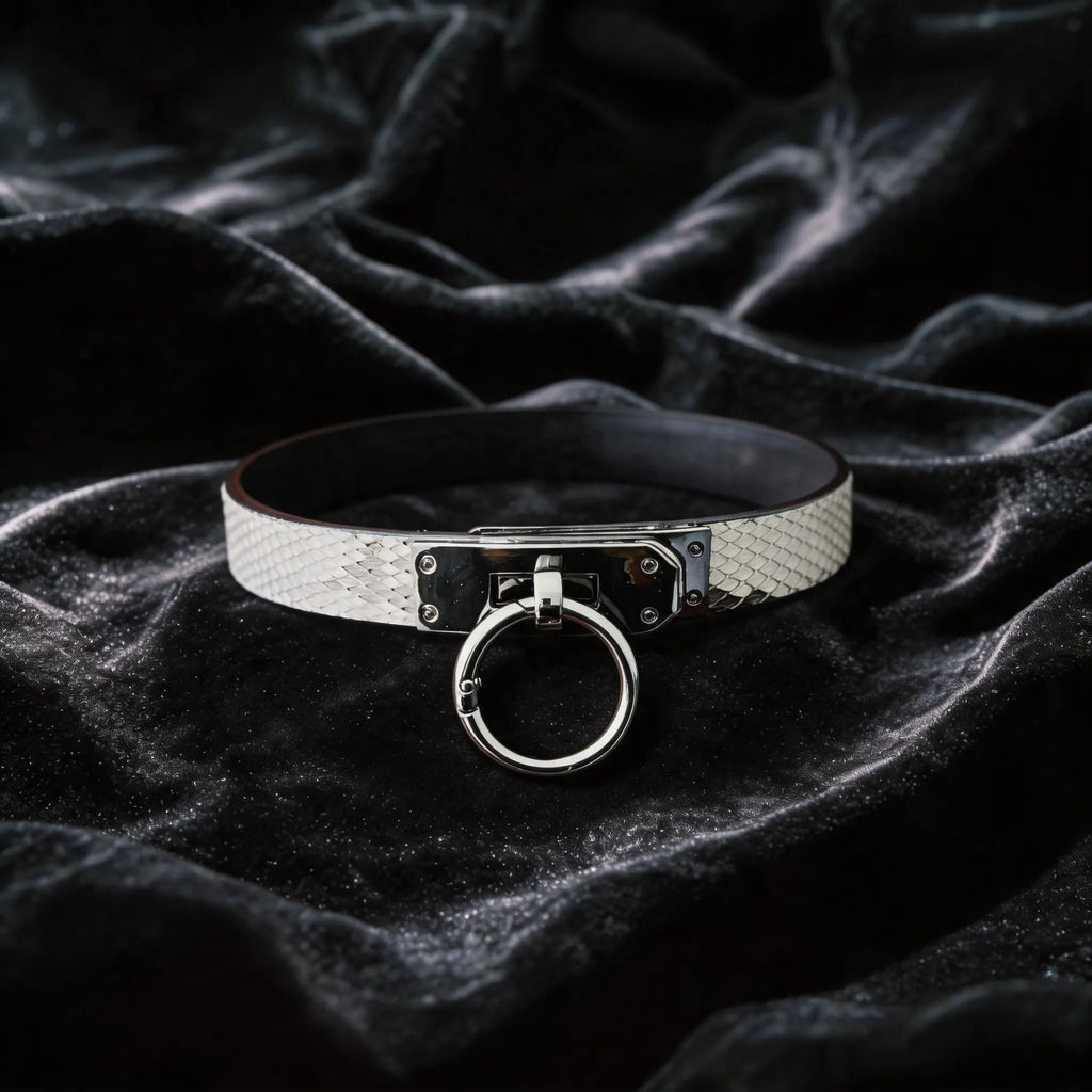Python Lock O-Ring Leather Collar white and black python-textured leather collar on black satin with O-ring front.
