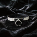 Python Lock O-Ring Leather Collar white and black python-textured leather collar on black satin with O-ring front.
