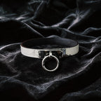 Python Lock O-Ring Leather Collar white and black python-textured leather collar on black satin with O-ring front.