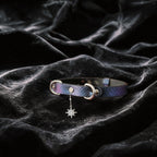 Python Star Pendant Leather Collar angled on black satin, showing purple and black python-textured leather and star pendant.