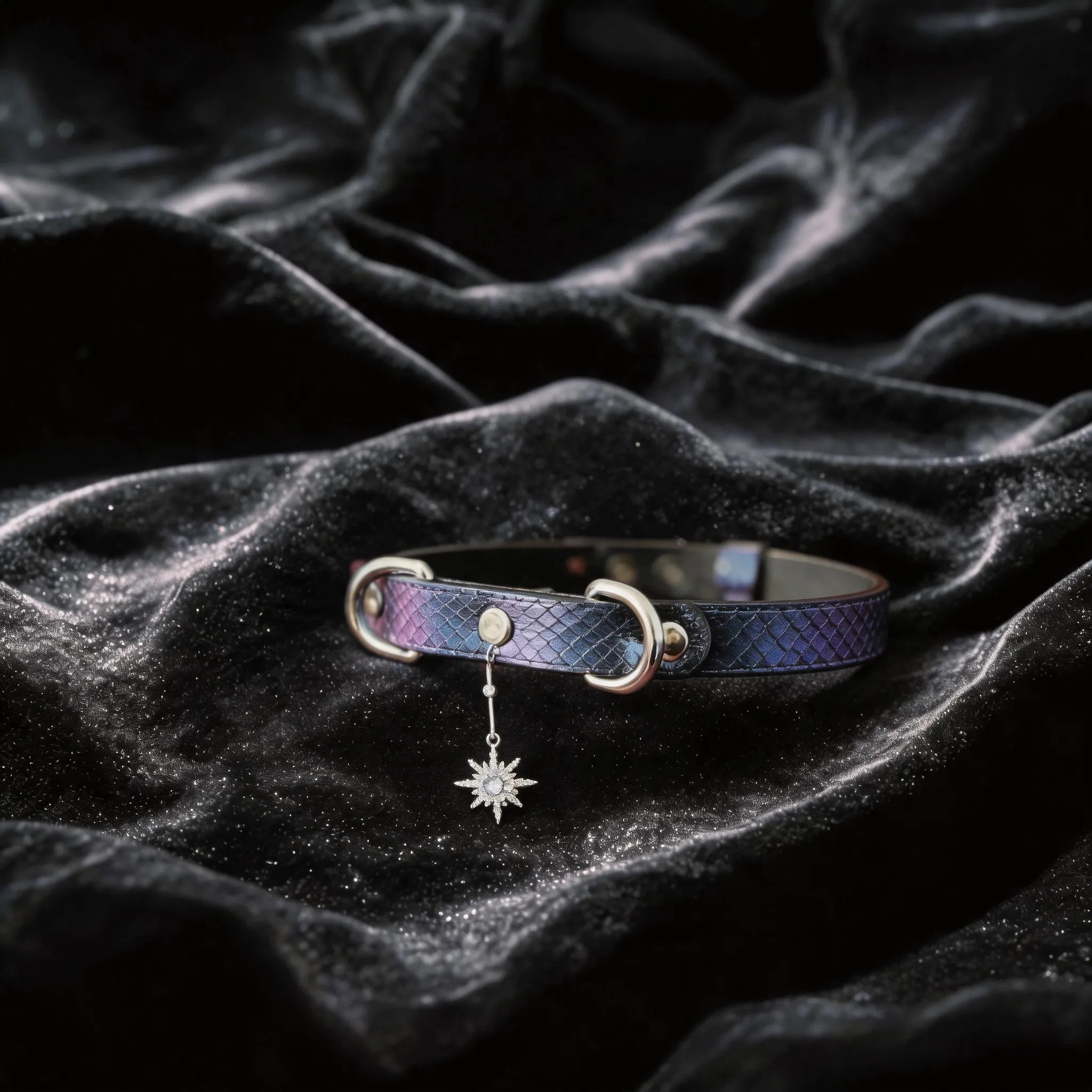 Python Star Pendant Leather Collar angled on black satin, showing purple and black python-textured leather and star pendant.