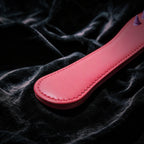 Rose Thorn studded leather paddle angle view with elongated silhouette and broad handle grip