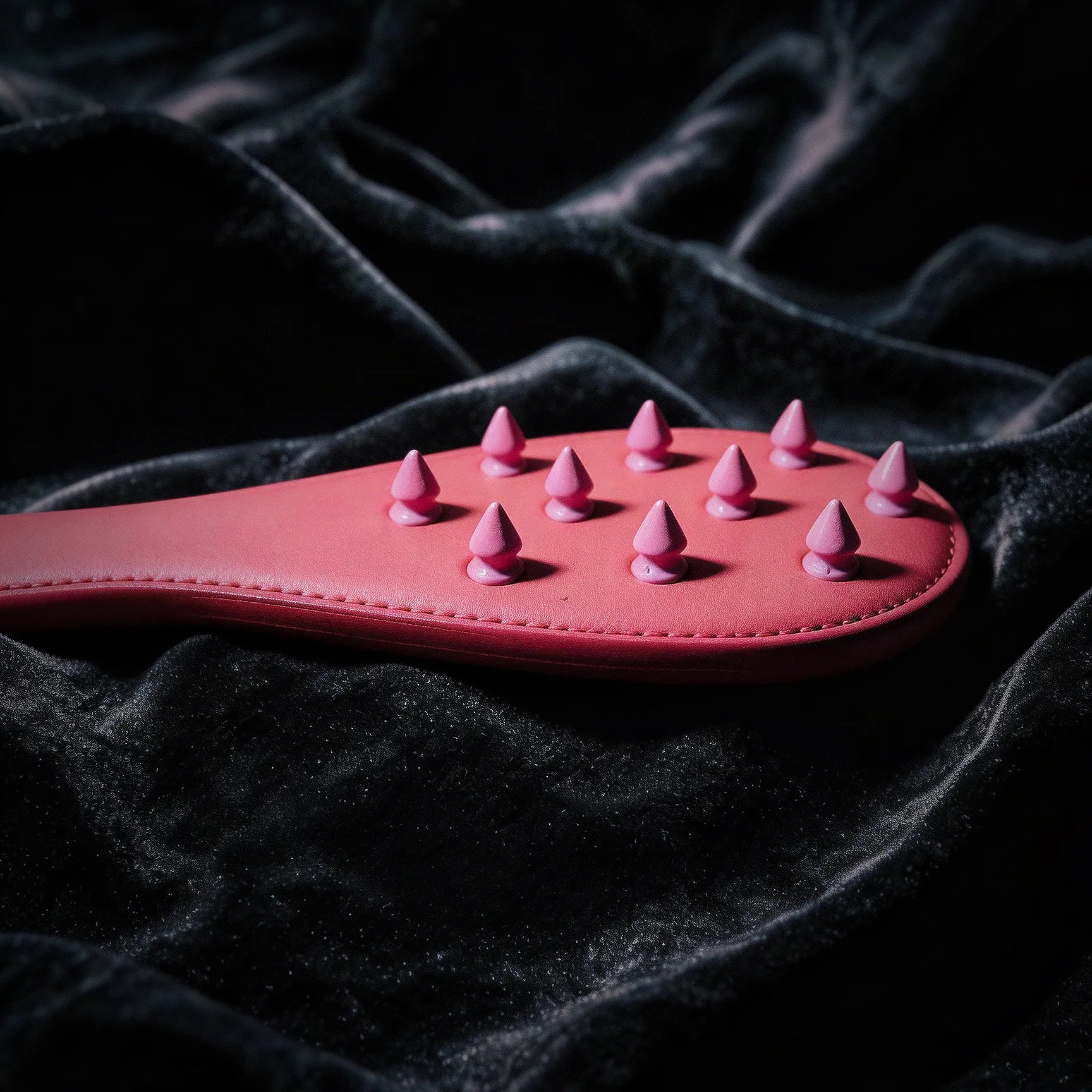 Rose Thorn leather paddle detail view with sculptural surface texture and rounded edge finish