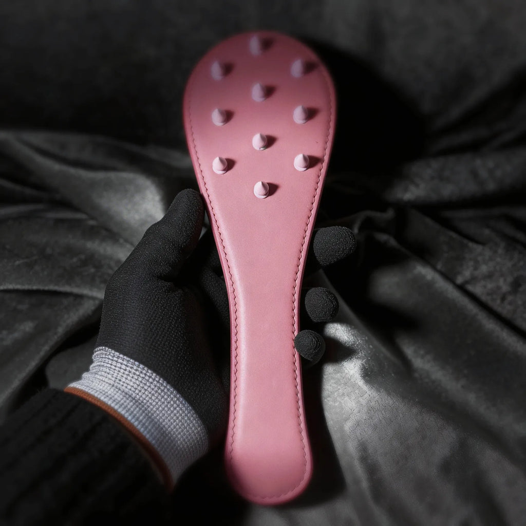 Rose Thorn leather paddle detail view with raised stud pattern and smooth blush leather finish