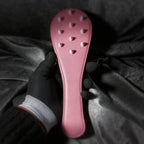 Rose Thorn leather paddle detail view with raised stud pattern and smooth blush leather finish