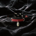 Serpent Mark Pendant Leather Collar black and crimson leather collar on black satin with serpent pendant.