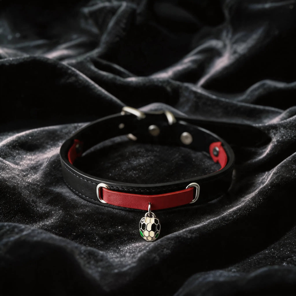 Serpent Mark Pendant Leather Collar hand-held studio detail showing serpent pendant and silver hardware.
