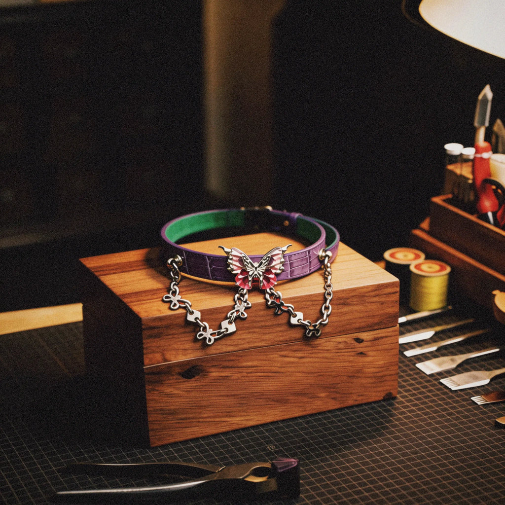 Violet Flutter butterfly chain leather collar studio display on a wooden stand with embossed lavender leather, mint inner accent