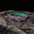 Violet Flutter leather collar detail view with butterfly centerpiece, floral chain drape, and silver-tone hardware
